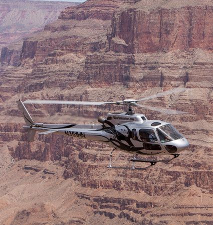 5 Star helicopter flying between the walls of the Grand Canyon