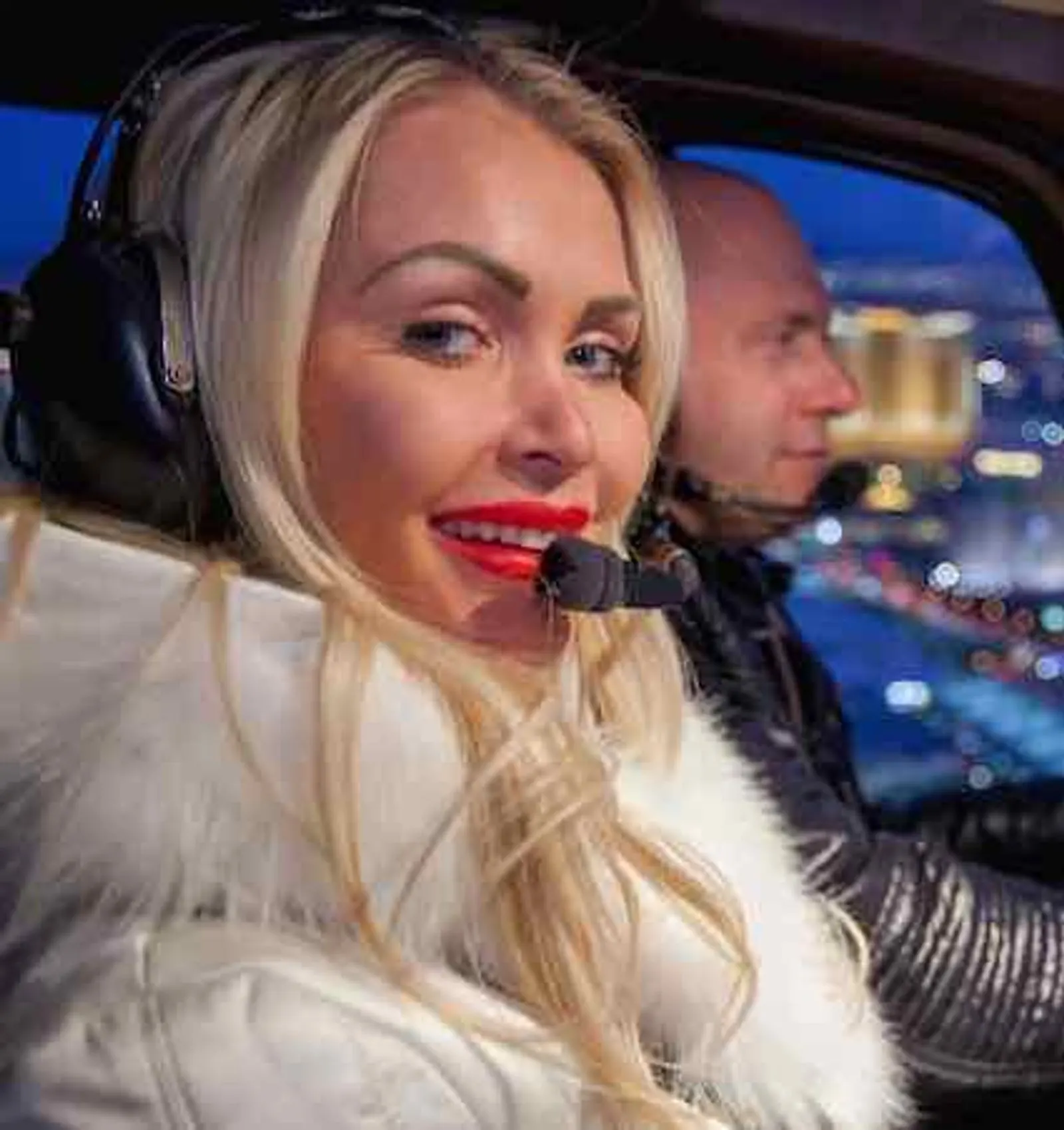 Guest wearing a headset in the helicopter before a night flight