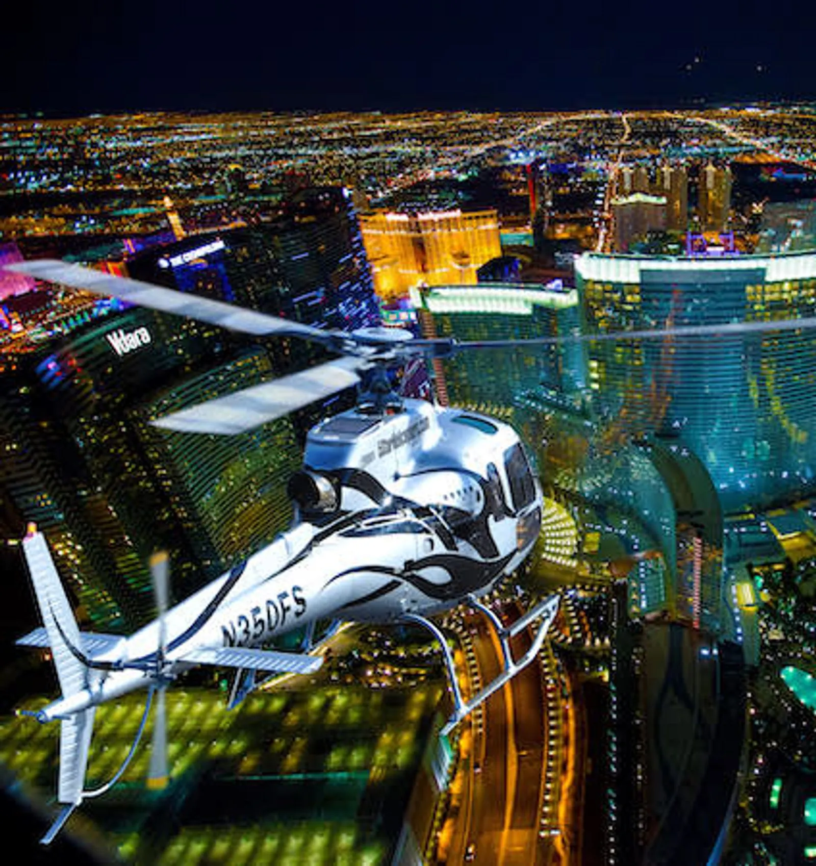 Helicopter over the Las Vegas Strip with resort lights below