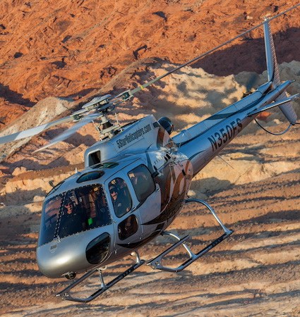 Close view of the silver 5 Star helicopter over the desert