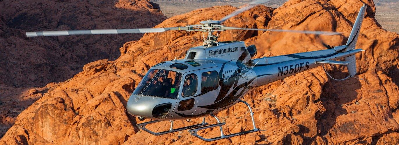 5 Star Helicopters Airbus AS350 N350FS flying low over the red sandstone of Red Rock Canyon