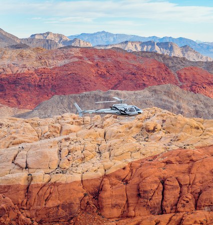 Snow on the Spring Mountains above Red Rock Canyon with a helicopter in flight