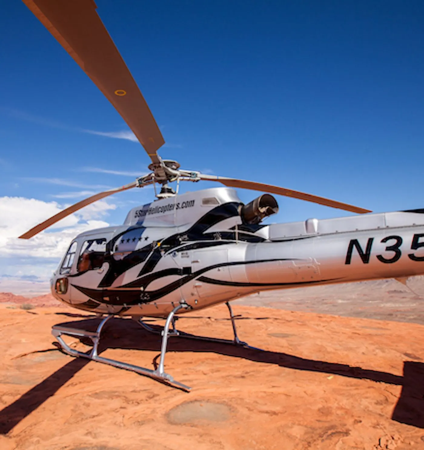 Helicopter parked on red rock in Valley of Fire