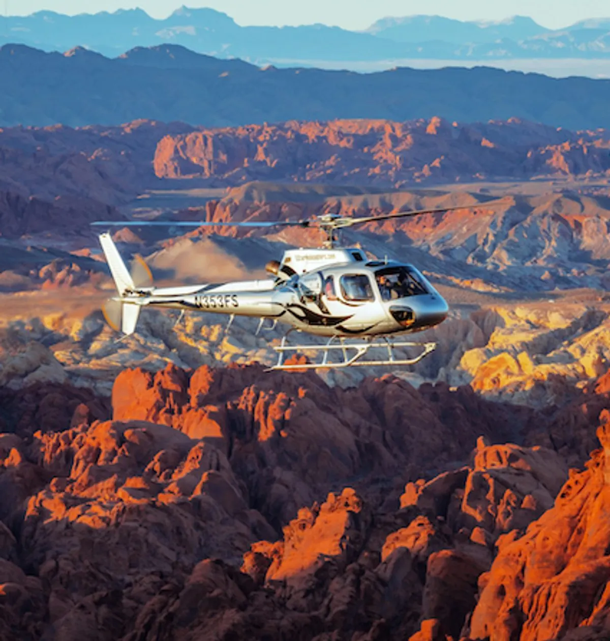Helicopter flying through Valley of Fire with the sandstone glowing orange