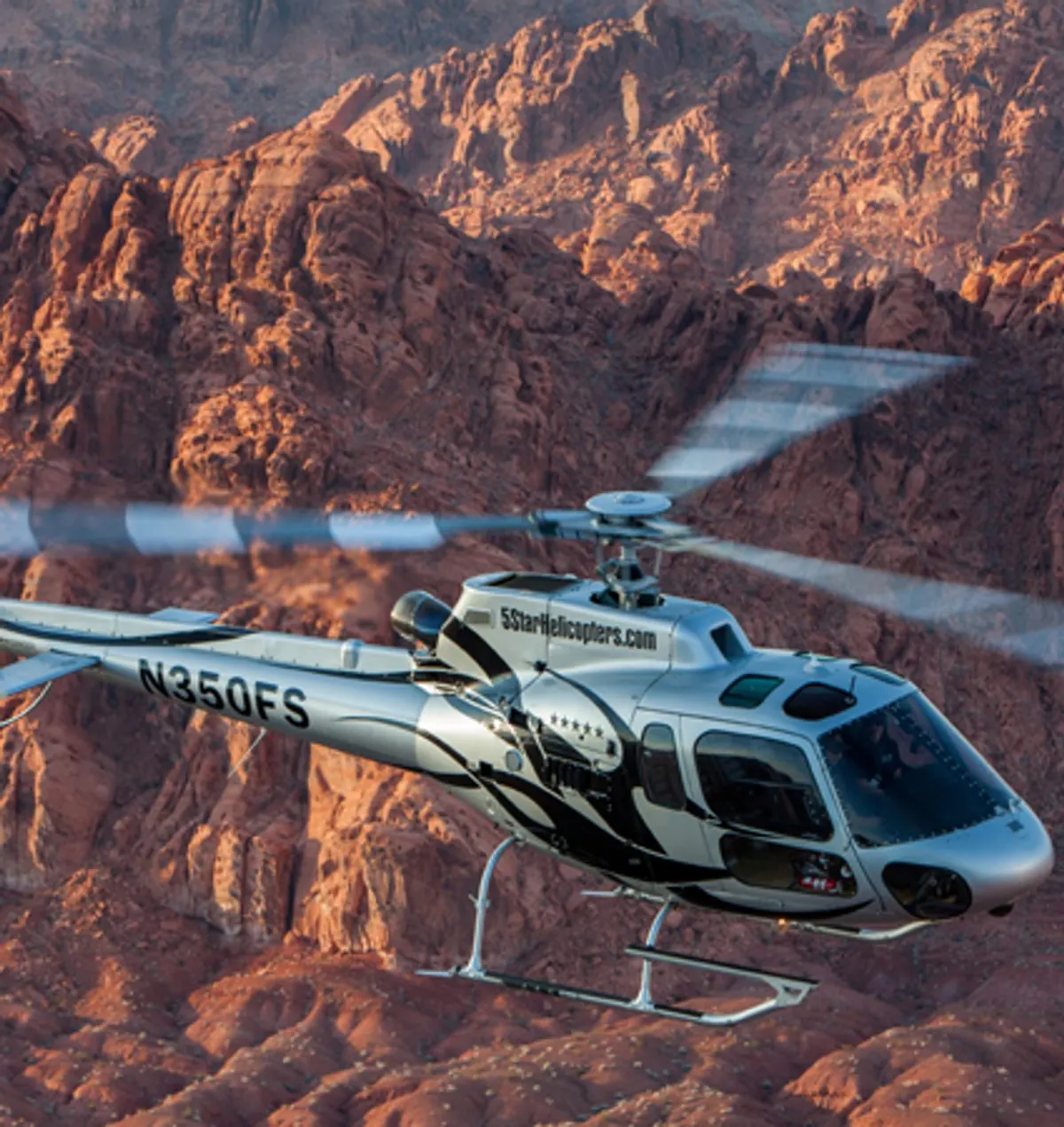 Helicopter flying low over Valley of Fire sandstone